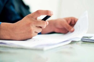 man holding pen and paperwork